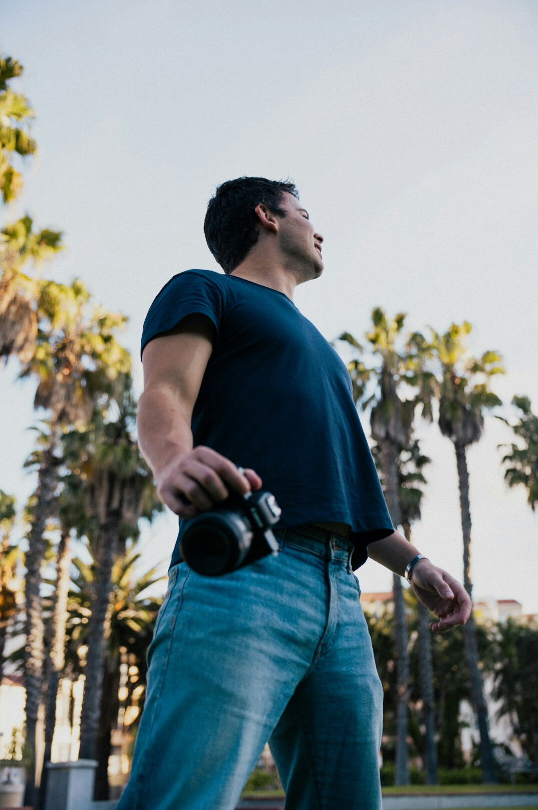 Camera operator with a professional broadcast camera on his shoulder outdoors